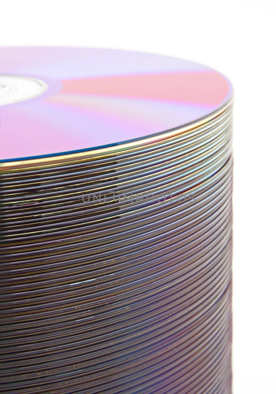 Purple CDs or DVDs on spindle, on white background, shallow DOF.