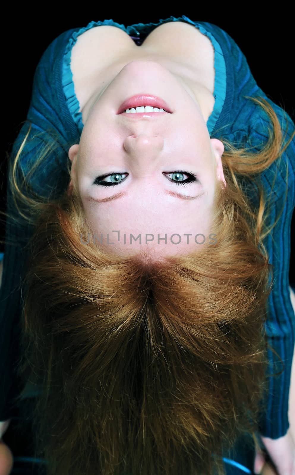 beautiful redheaded girl making a back- bend