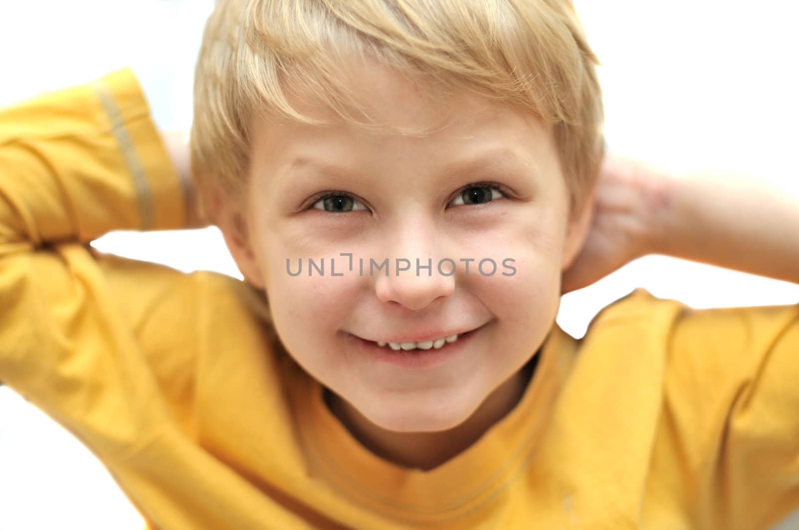 little adorable young boy sitting in chair and smiling