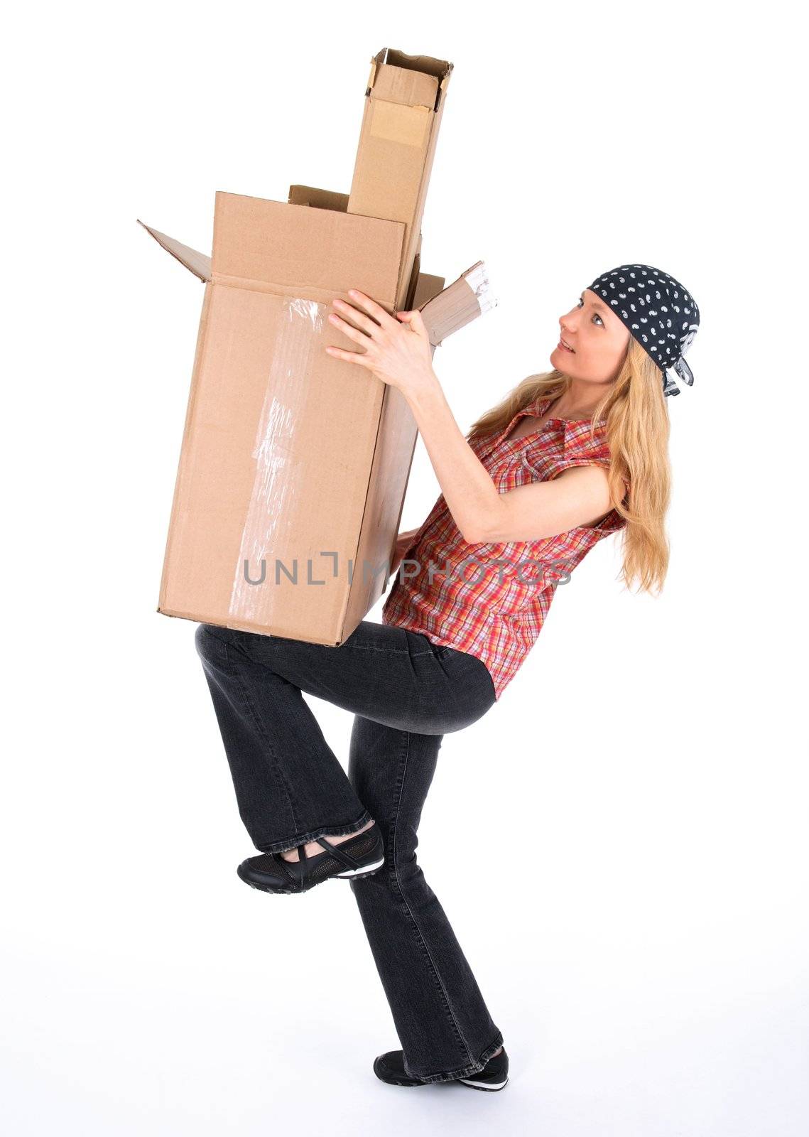 Girl balancing with cardboard boxes, white background.