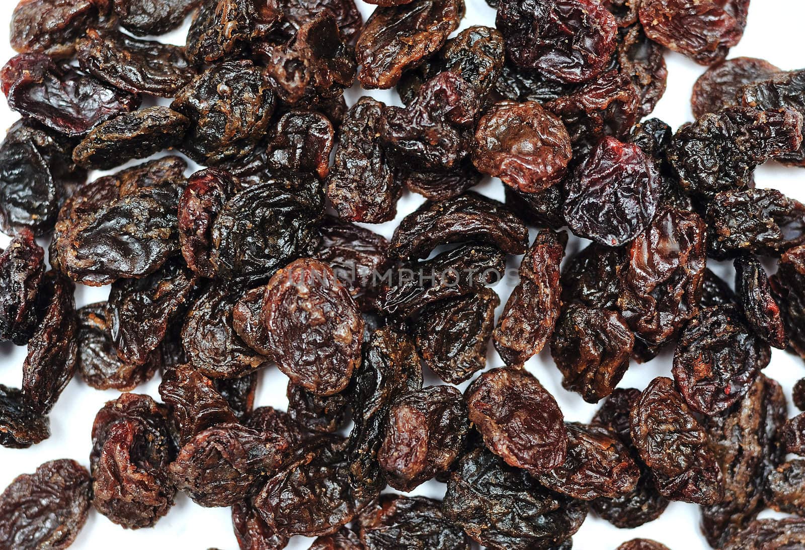 Black Jumbo raisins(very big raisins) over white background