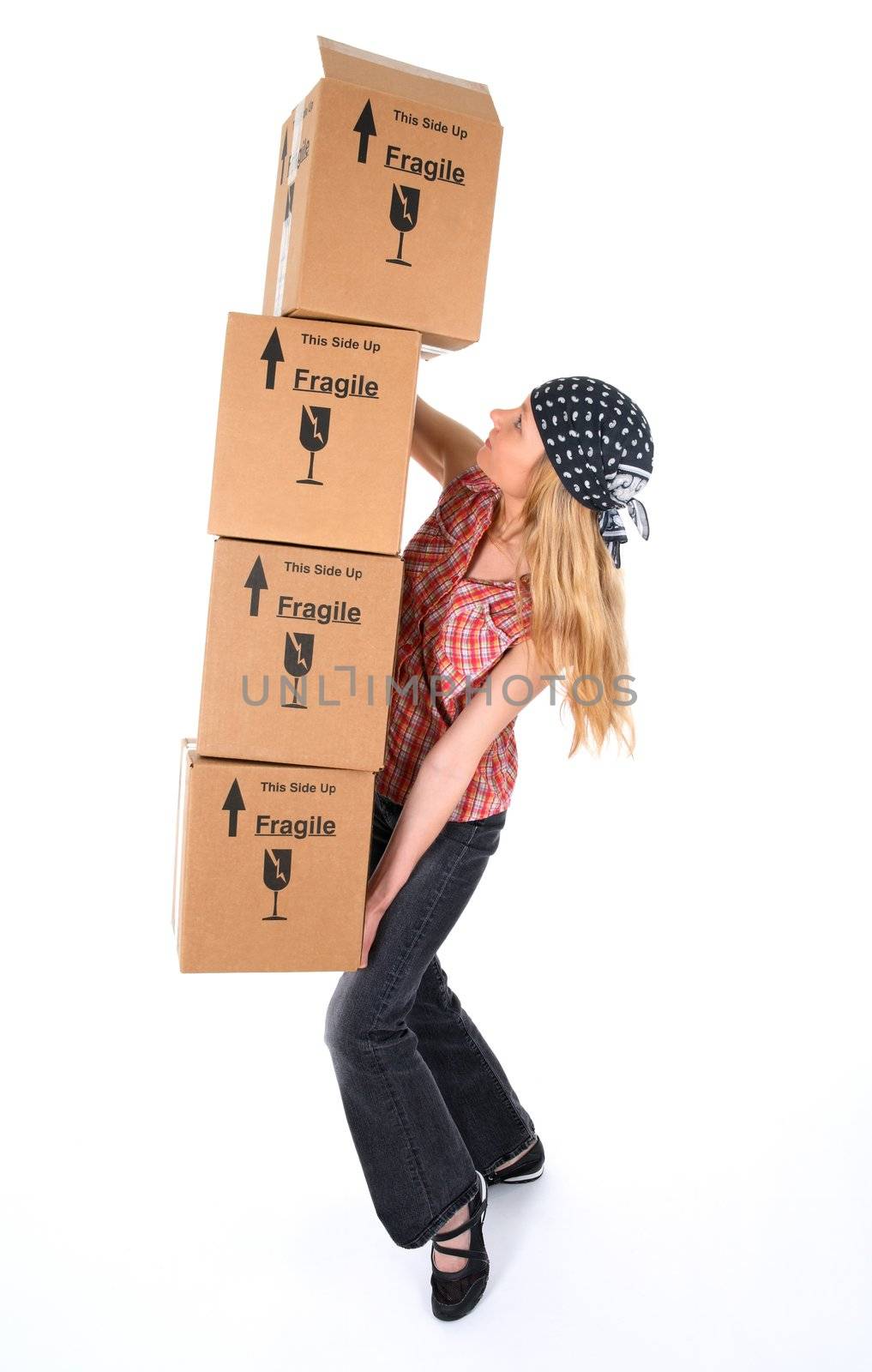 Woman balancing with a stack of cardboard boxes, ready to fall.