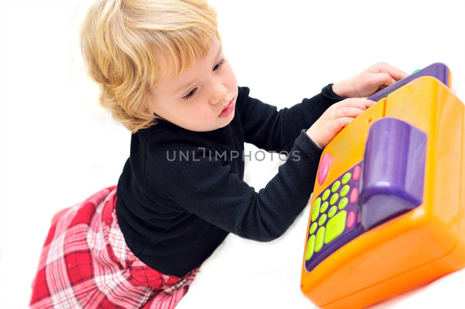 toddler girl playing with  cash register over white

