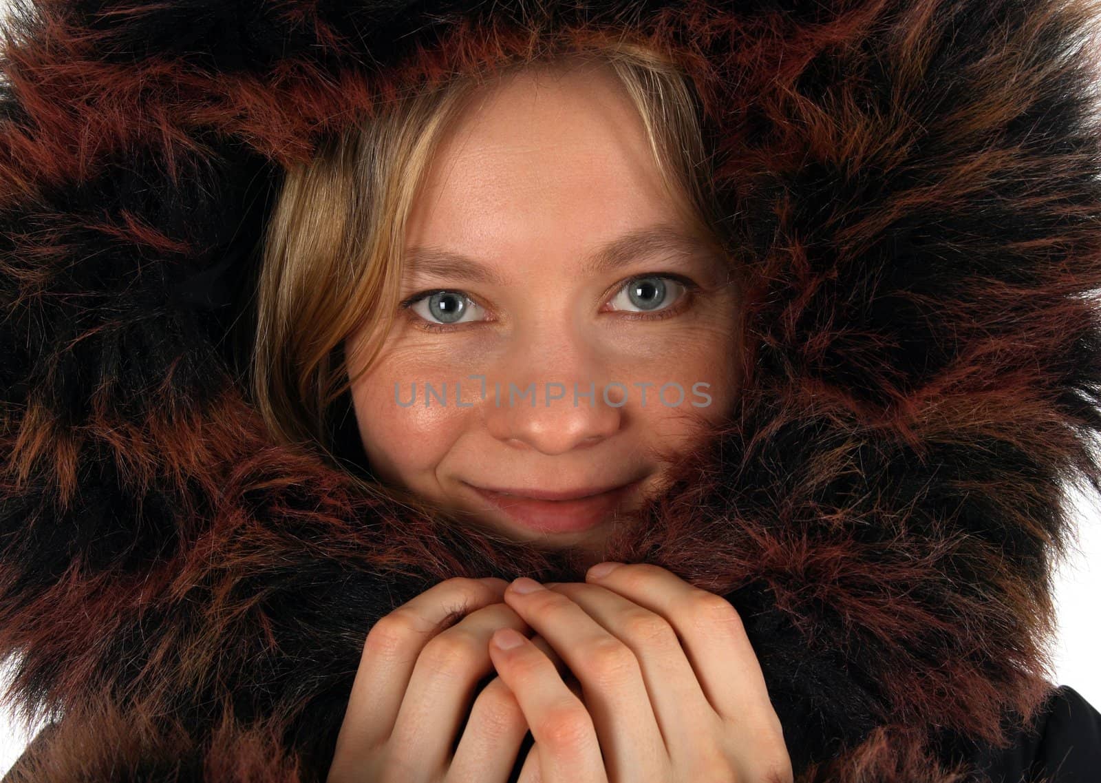 Smiling young woman with a fur hood by anikasalsera