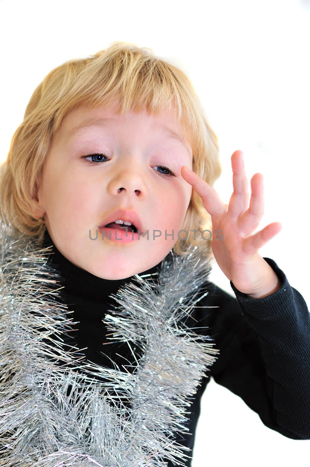 little girl feeling that she has a eyewinker in her eye, she is wearing christmas decoration