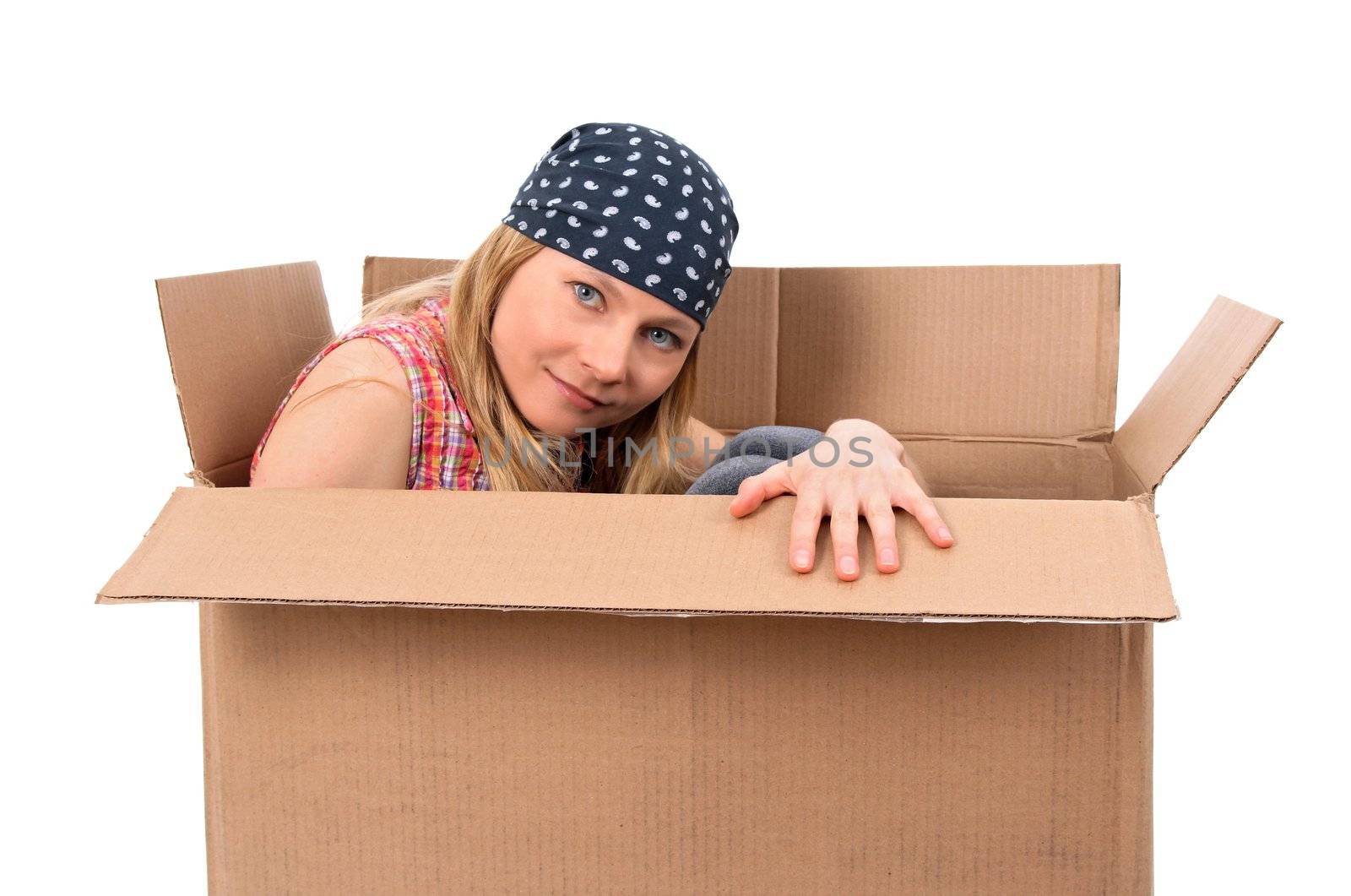 Girl hiding in a cardboard box. Isolated on white.
