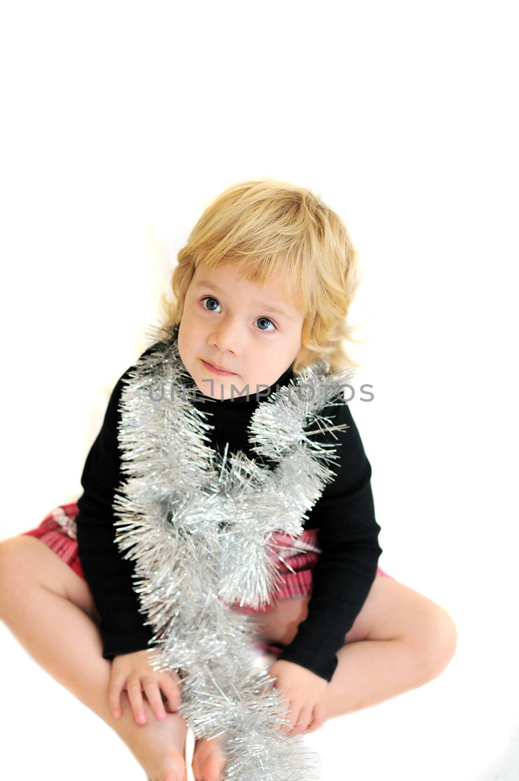 funny girl wearing christmas decoration siting on the white background