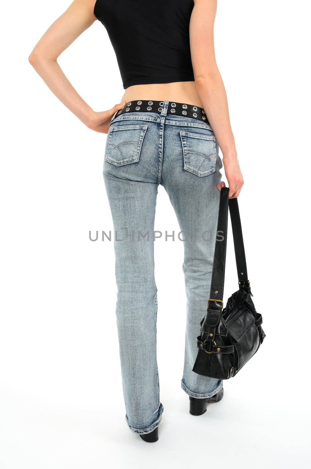 Urban young woman with handbag, wearing jeans.