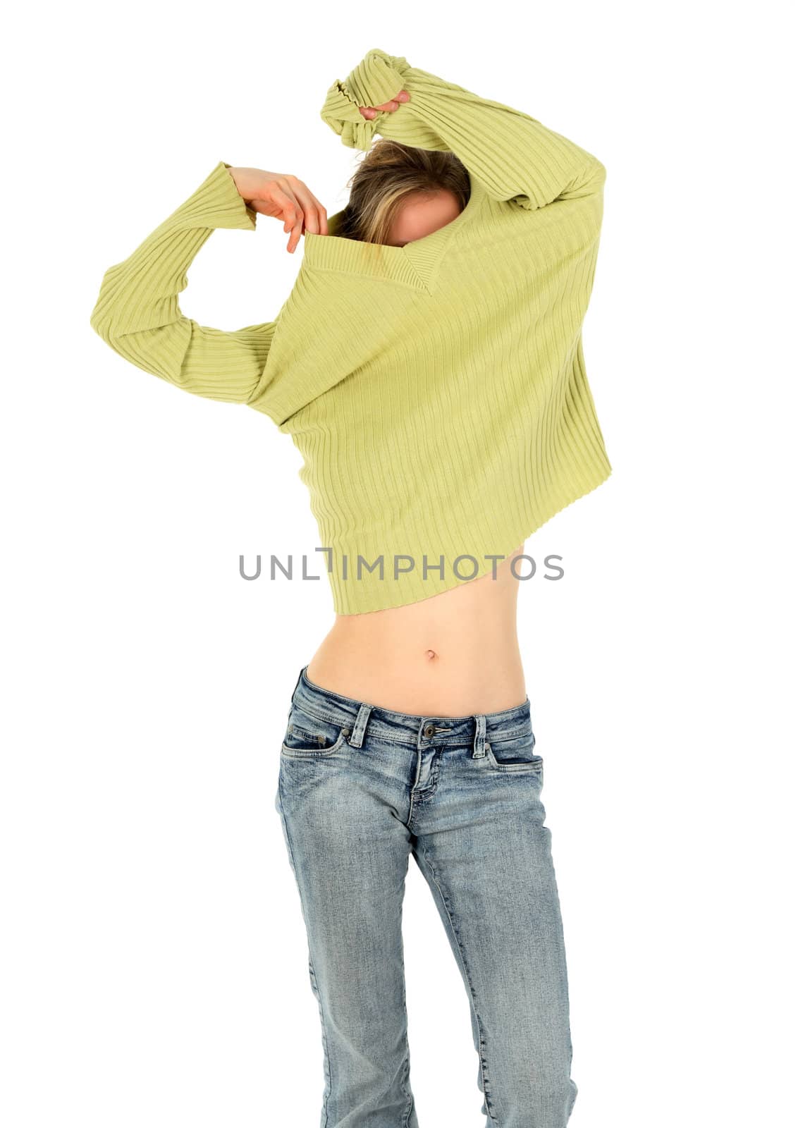 Woman in jeans takes off a green sweater by anikasalsera