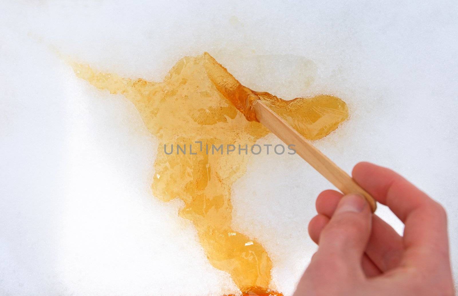 Maple taffy on snow, traditional treat in Quebec, Canada.