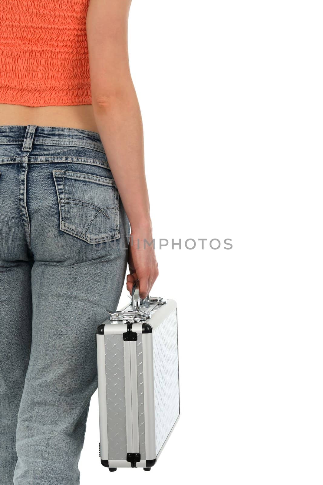 Young woman in blue jeans holding a metal case.