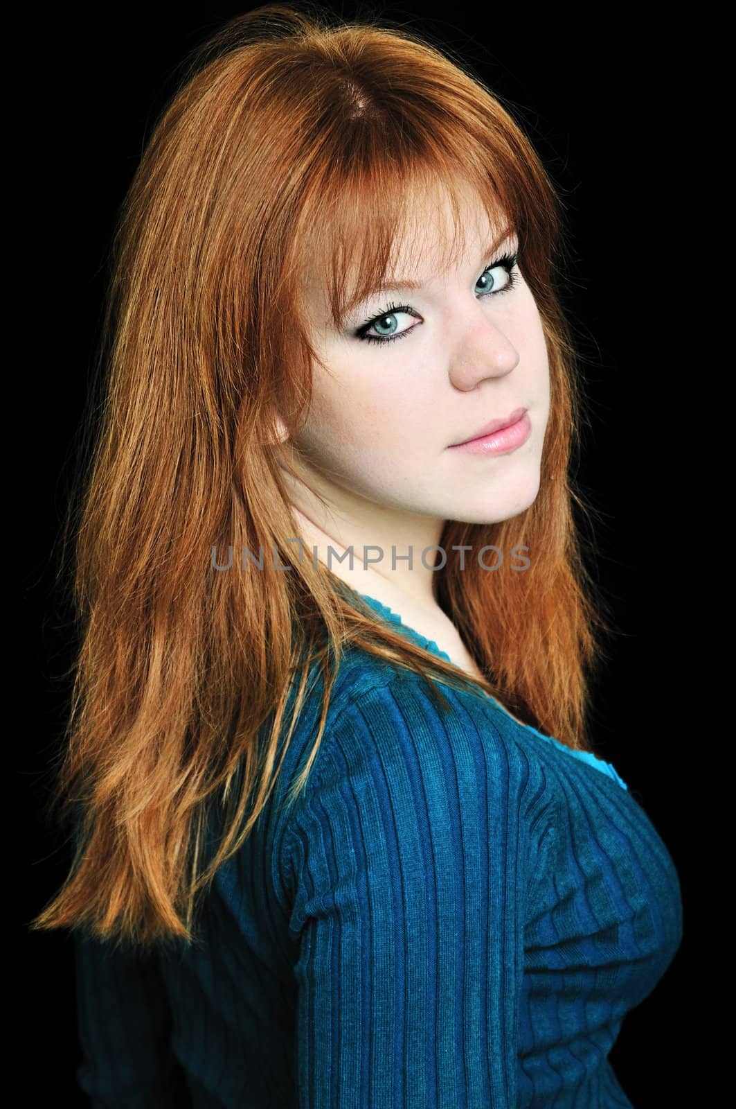 portrait of redheaded girl over the black background
