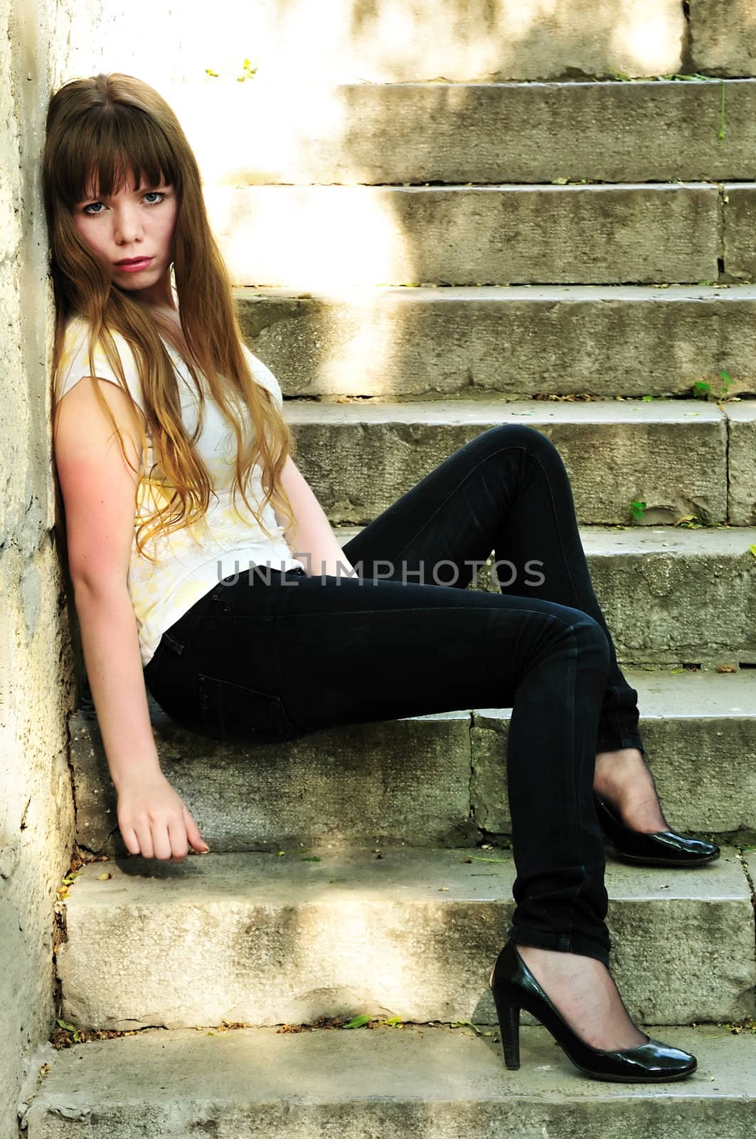 sad lonely girl sitting on the stairs