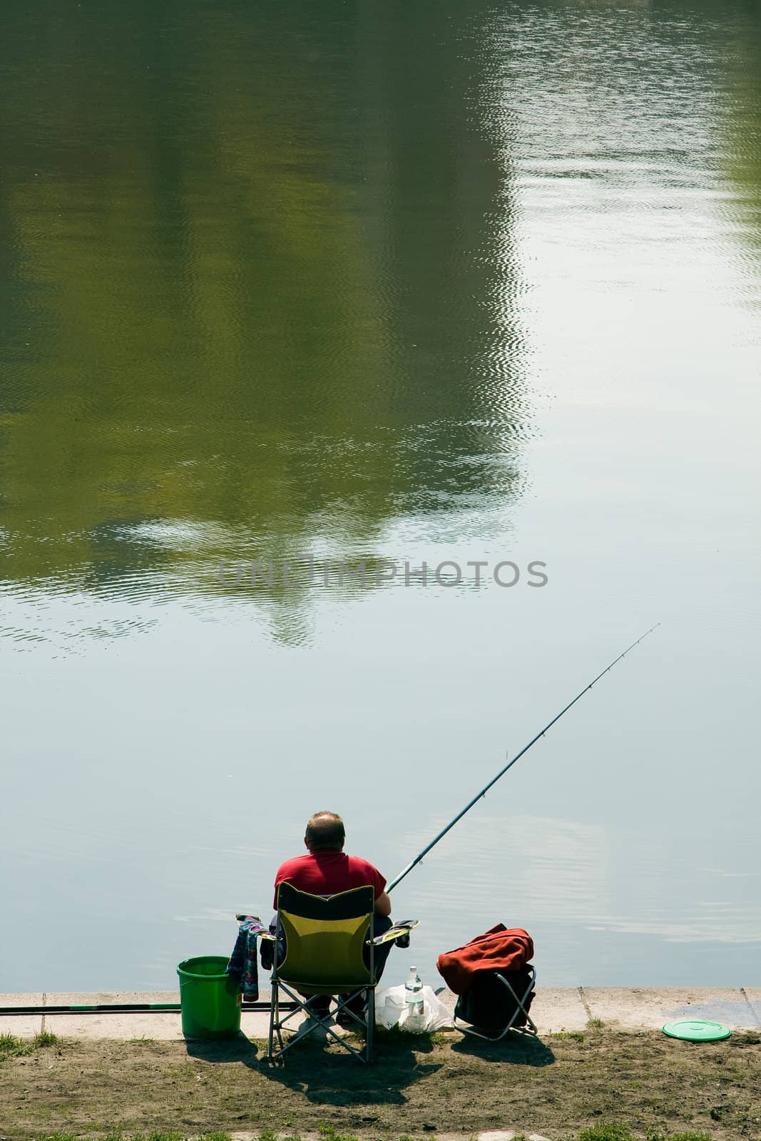 Angler on coast of river.