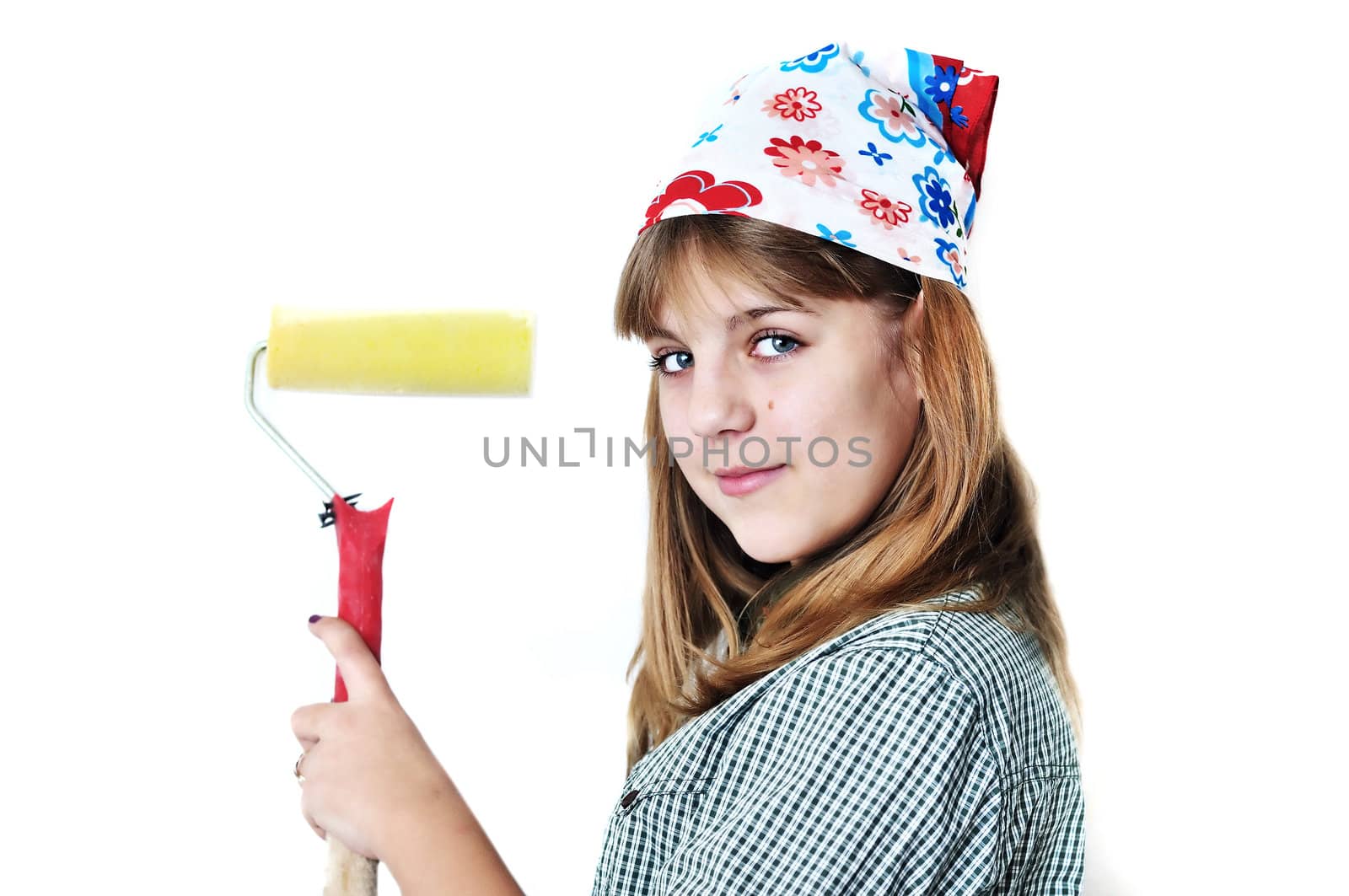 cute teenage girl using roller to paint wall isolated on the white background
