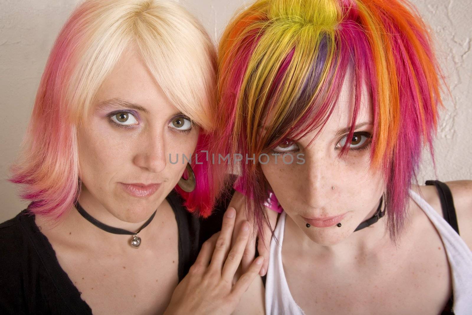 Two hip girls with brightly colored hair