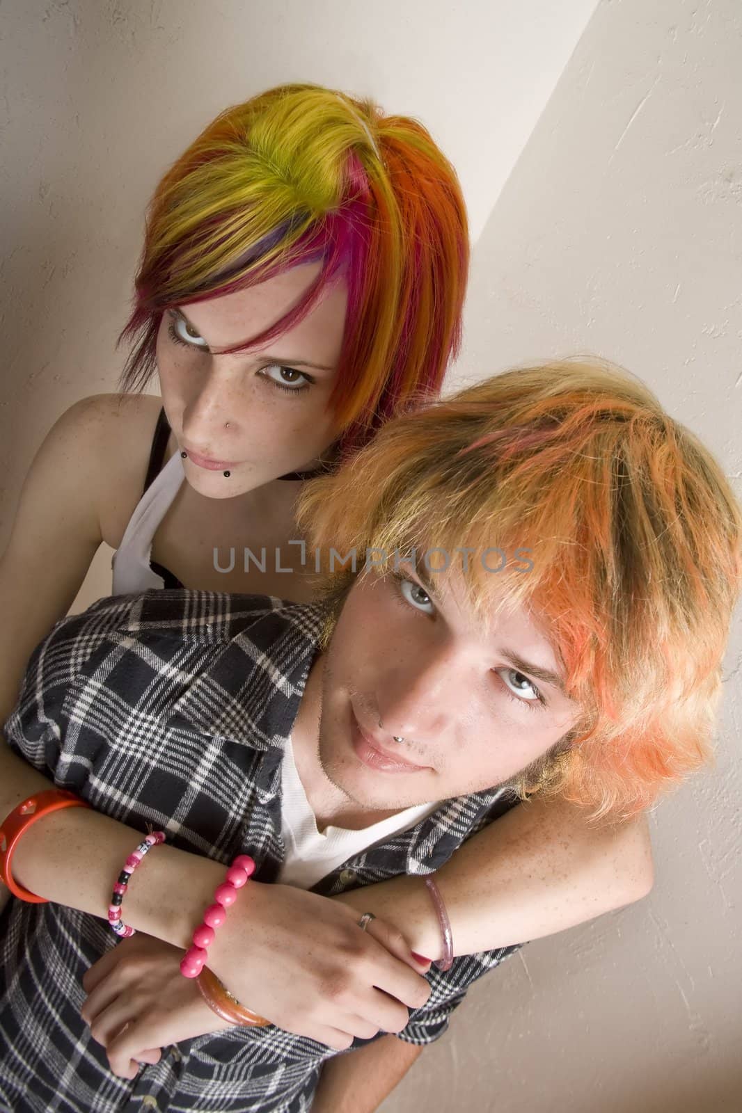 Young Couple with Bright Colored Hair Embrace by Creatista