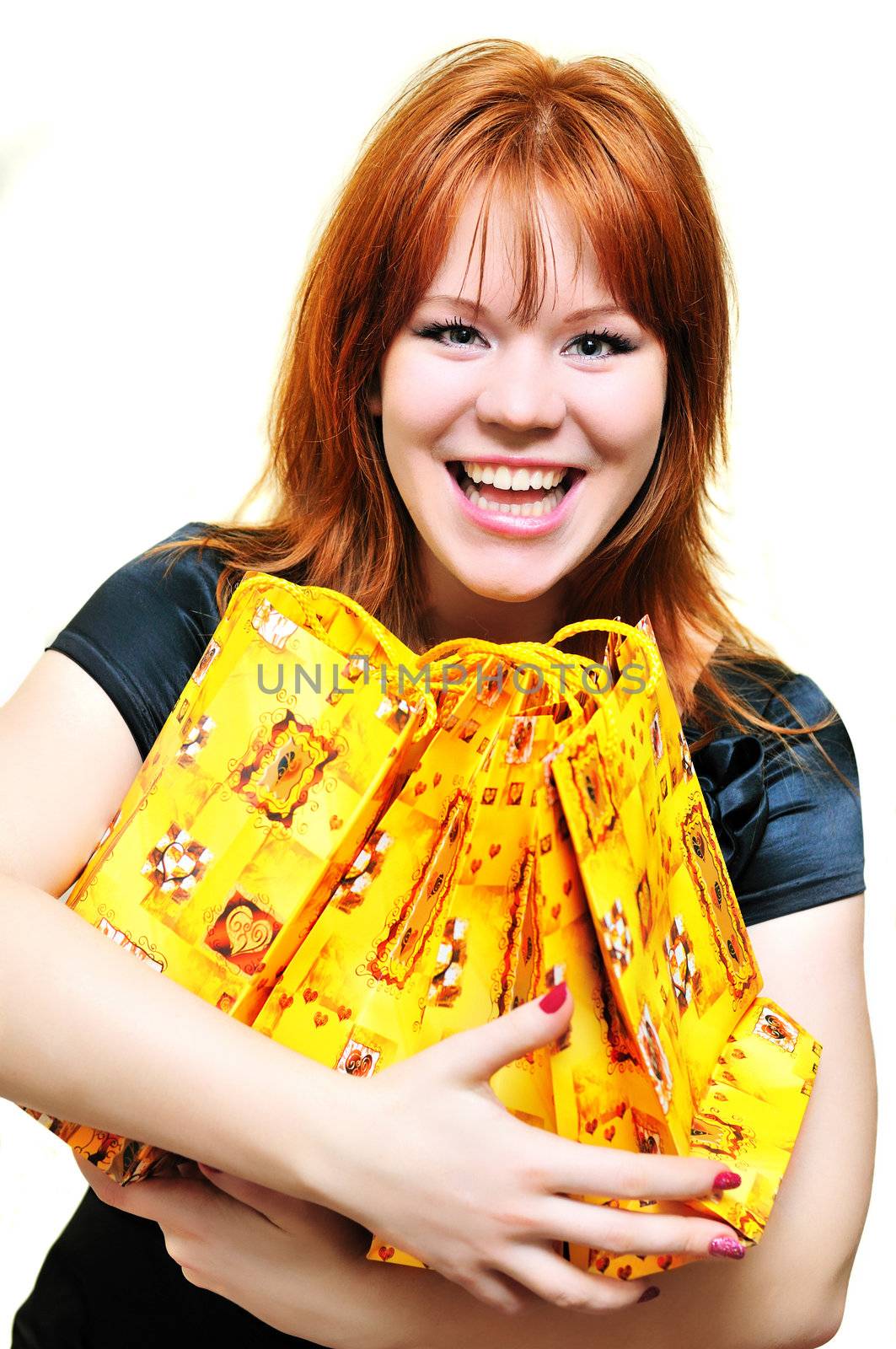 redheaded laughing girl after shopping over the white