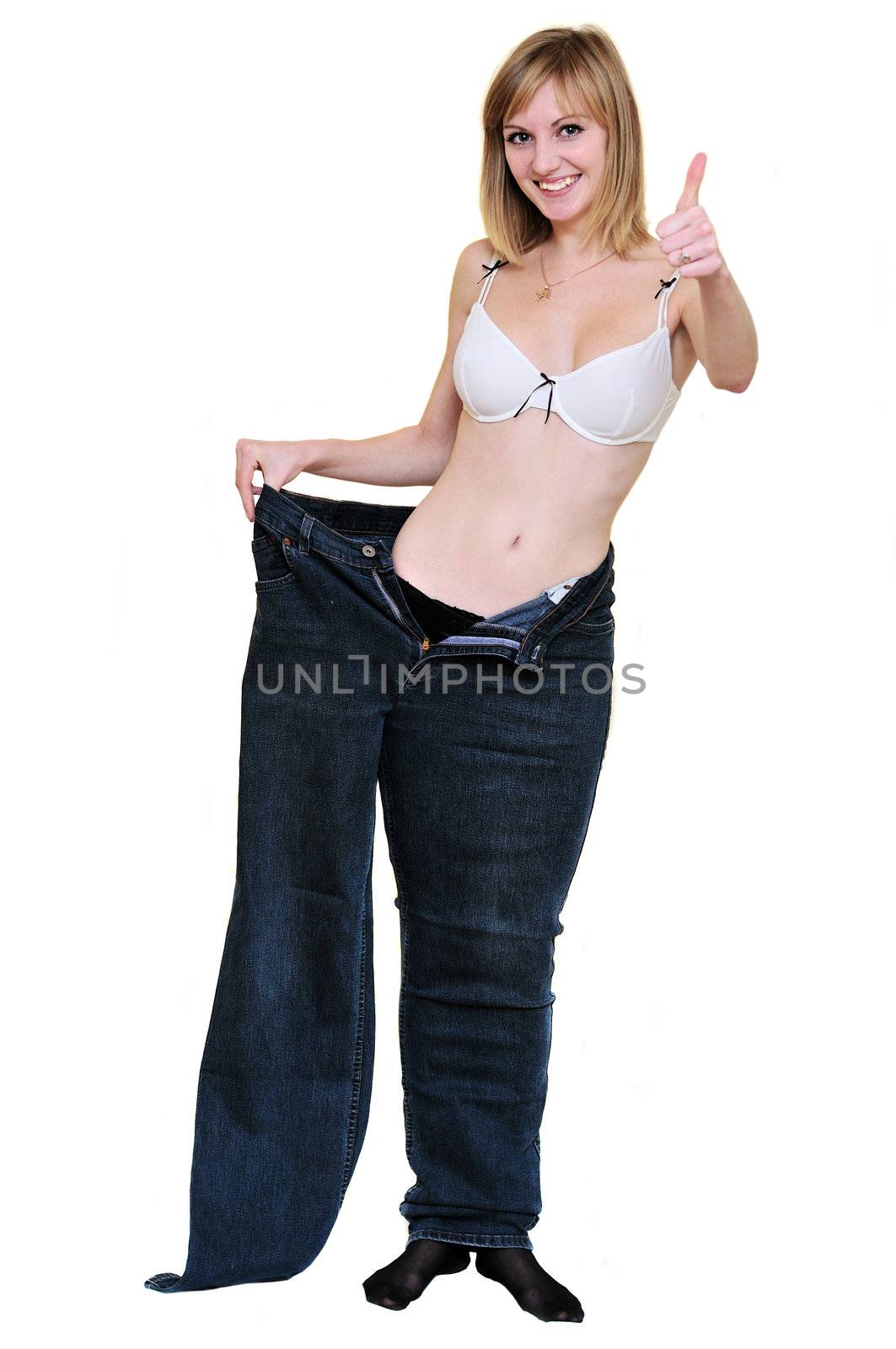 slim girl after diet in one  leg of her old jeans