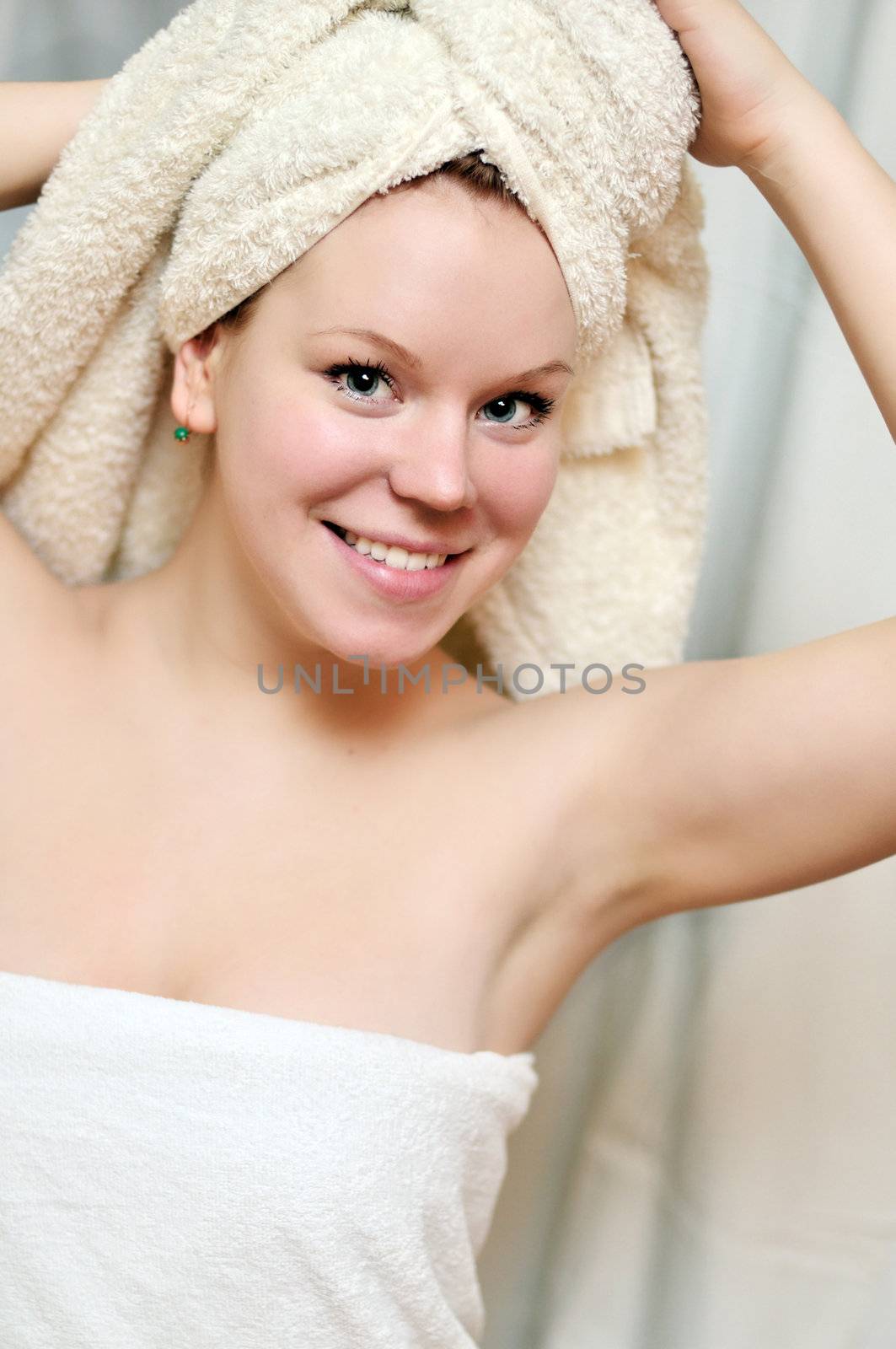  young beautiful woman after bath wearing towels
