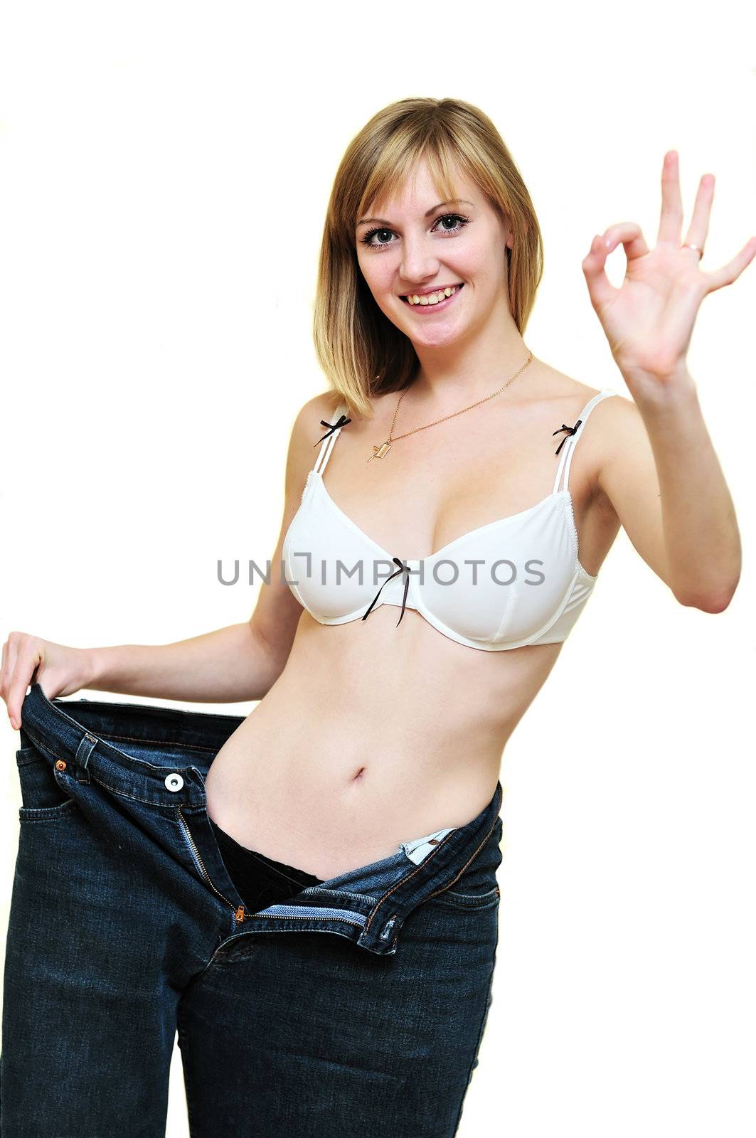 slim girl after diet in one leg of her old jeans
