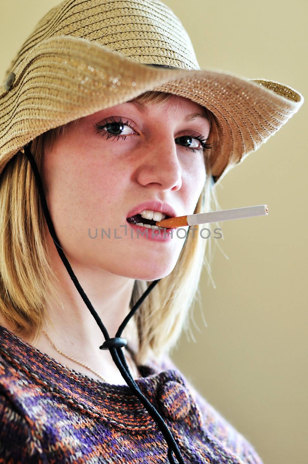 Beautiful Cowgirl with cigarette in her mouth
