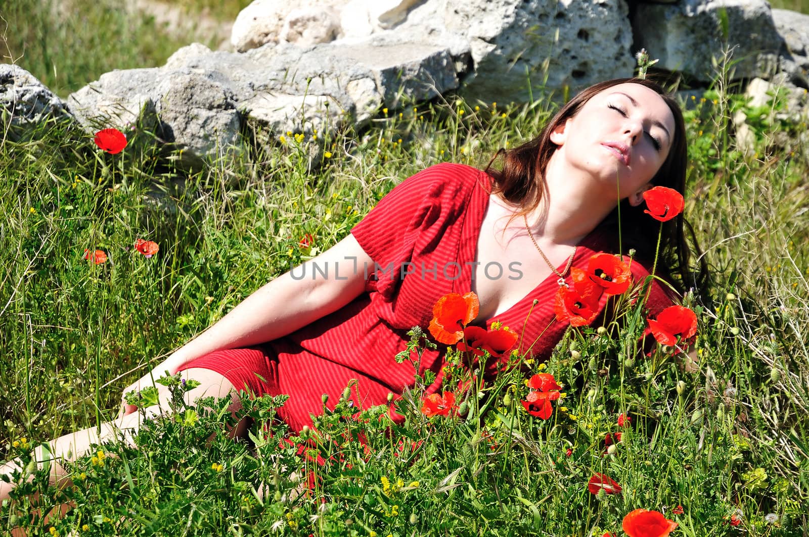 beautiful lady  relaxing in field of poppies
