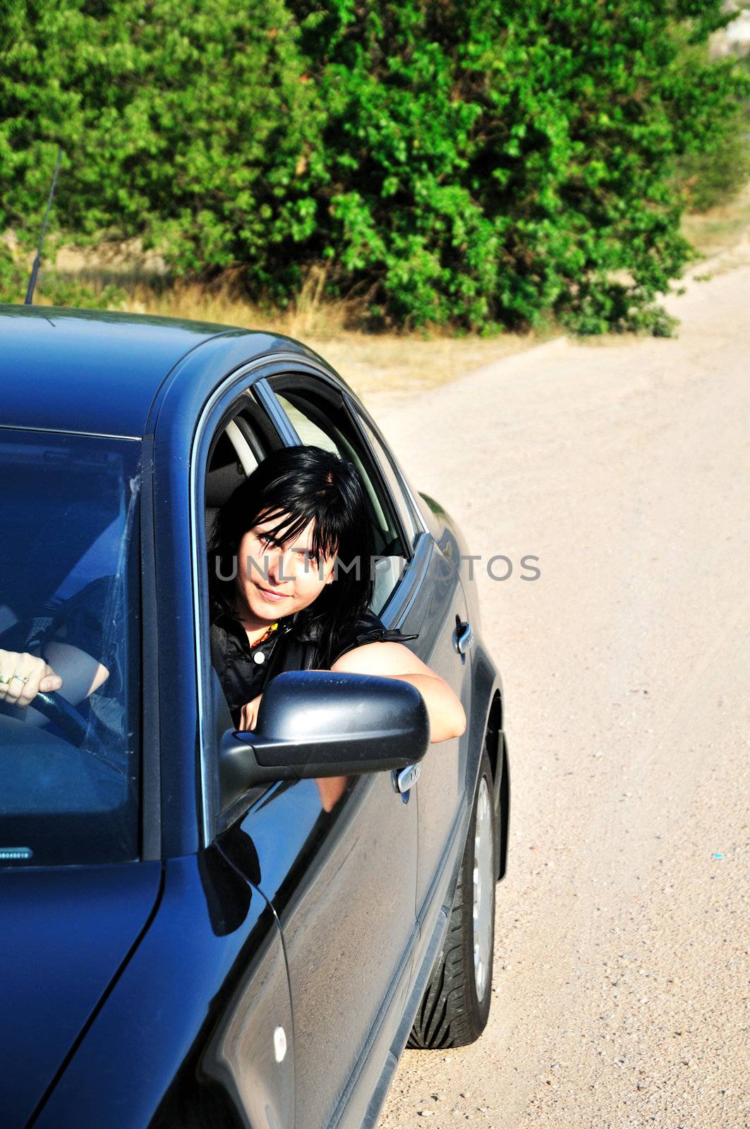 oung brunette woman driving a car outdoors
