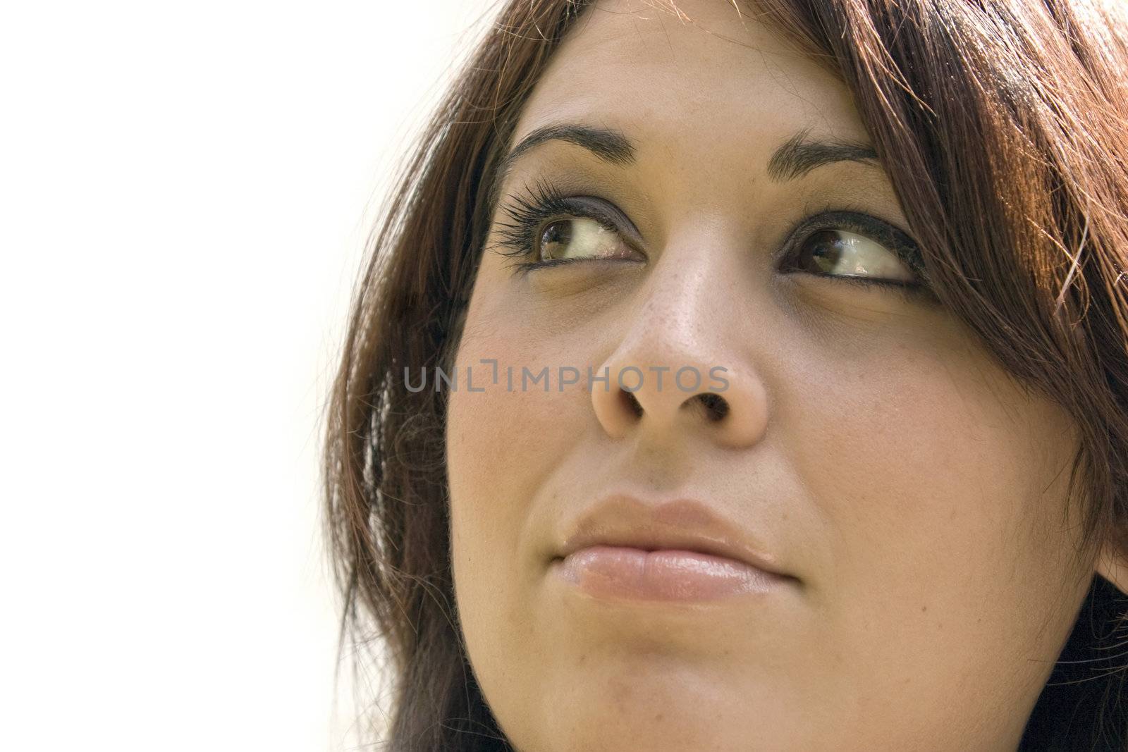 A young woman is thinking about something and looks to be in deep thought. Plenty of copy space with the girl isolated over white. 