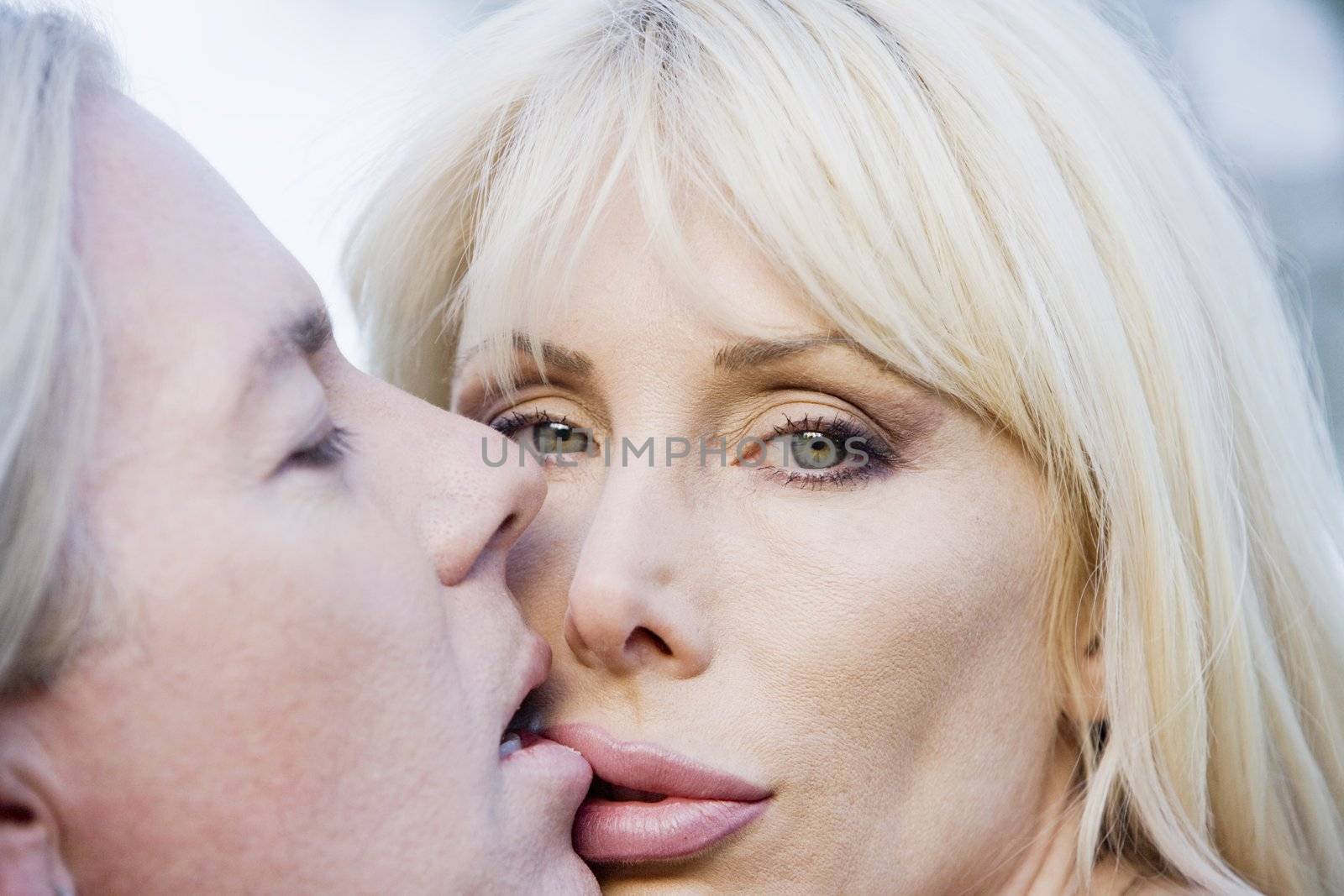 Close up of a pretty woman kissing a man