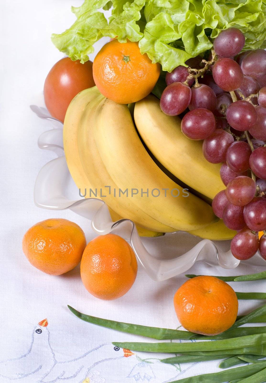 Assorted fresh vegetables and fruits in a vase 