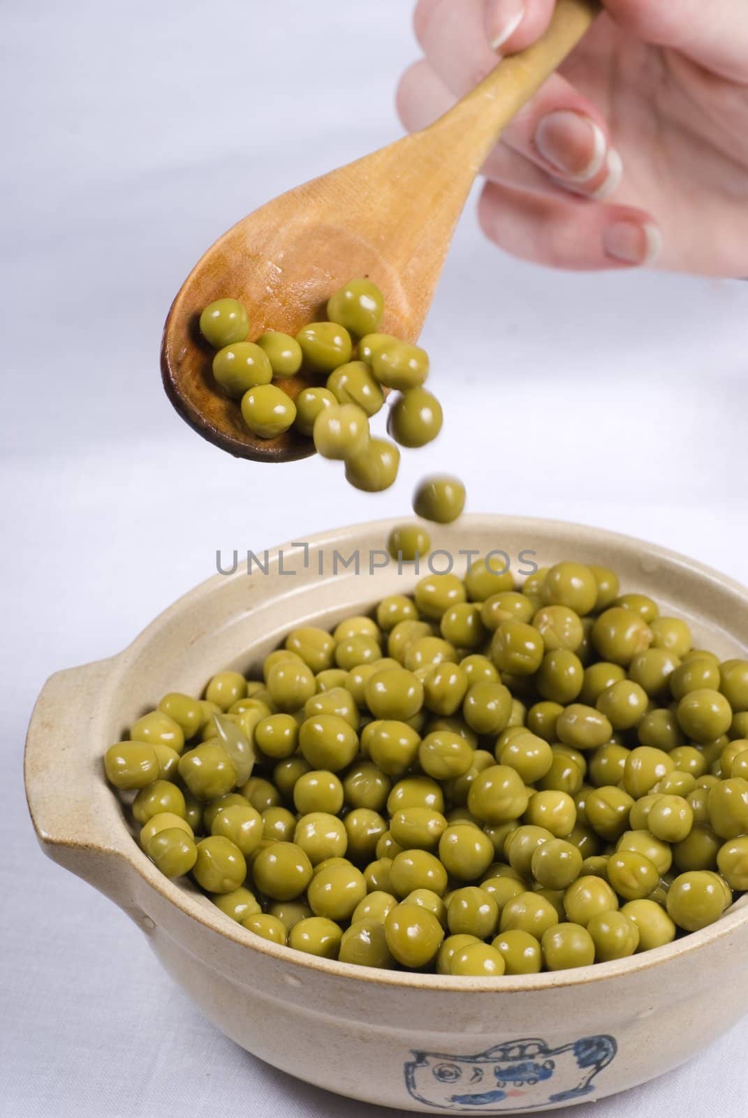 Spoon of green pickle peas