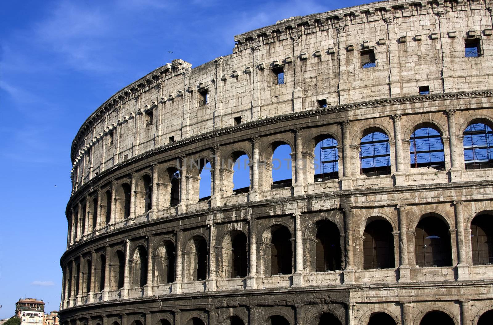 Antique colisseum in Rome over blue sky