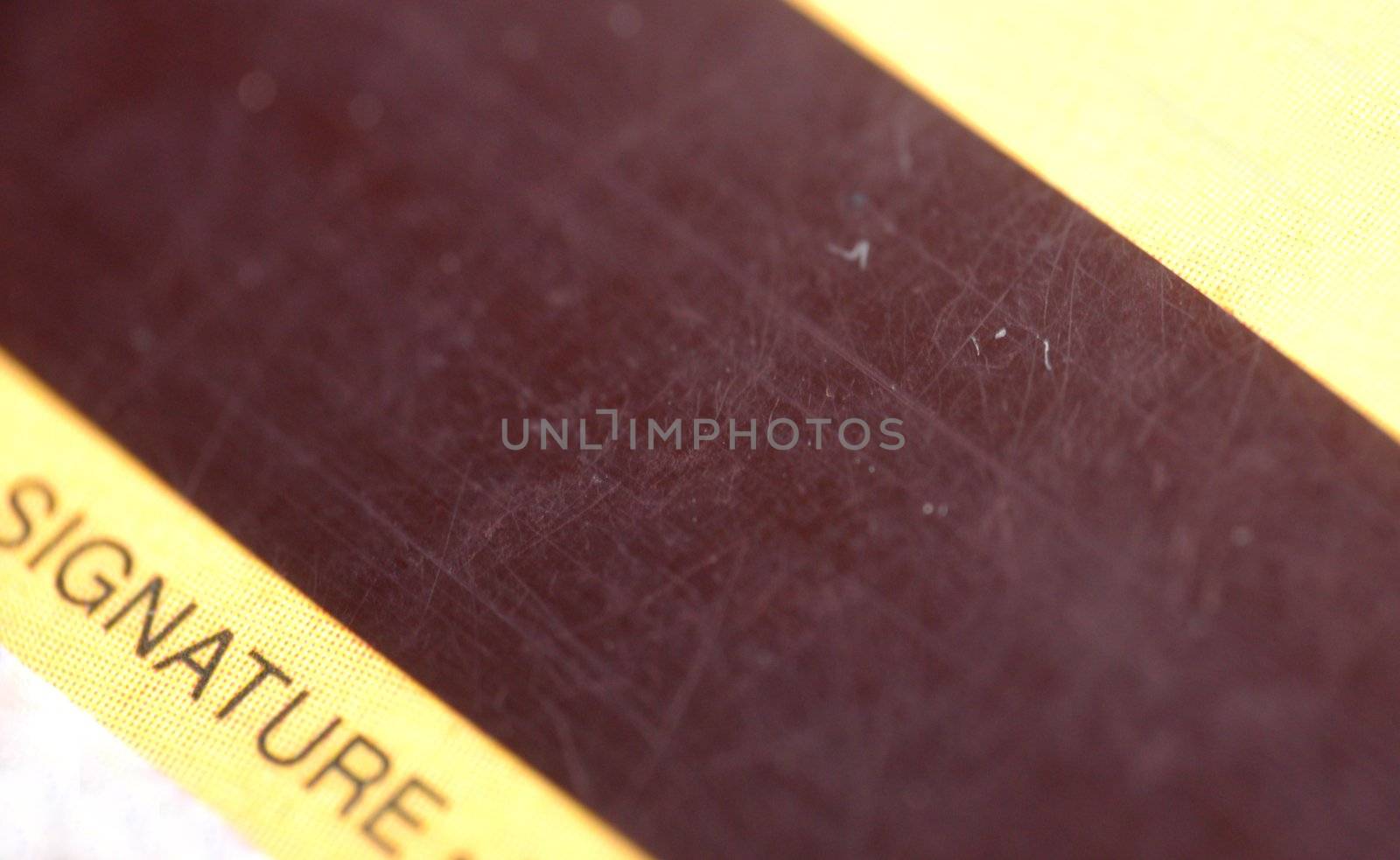 macro pattern of pretty used magnetic strip of credit card, contain word "signature"