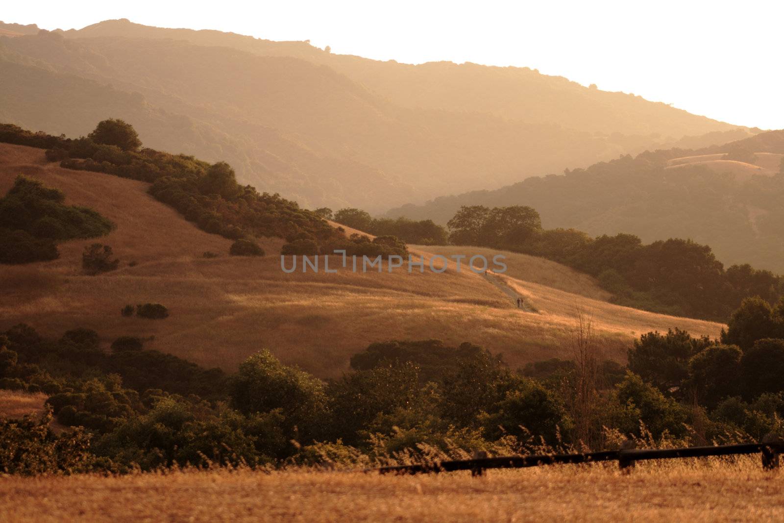 smoke from nearby fires bring a brown haze to the foothills just before sunset