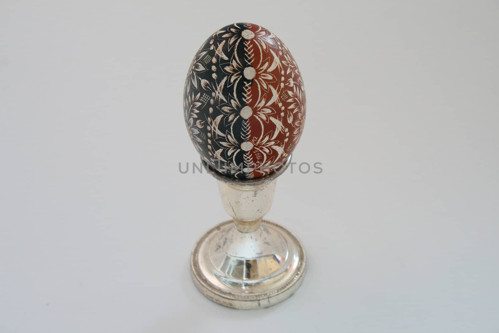 brown & black easter egg on white background