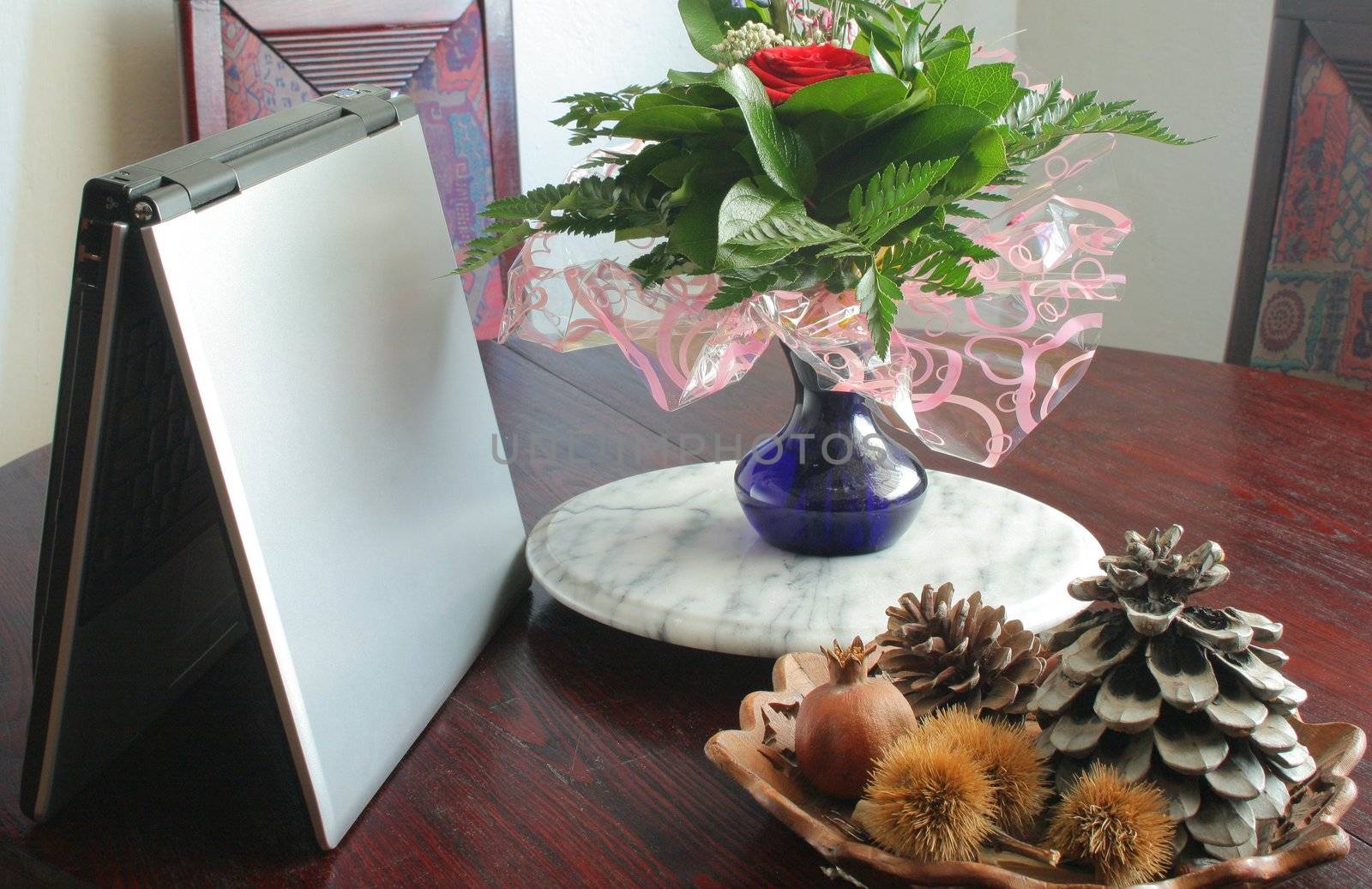 Laptop computer on the table with flowers