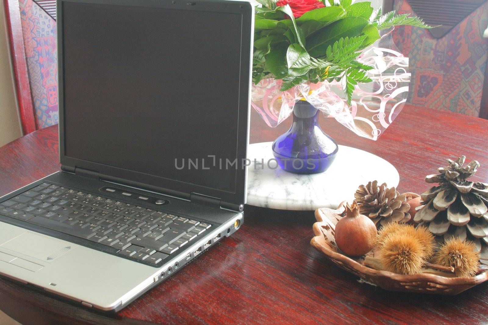 laptop on the table with flowers