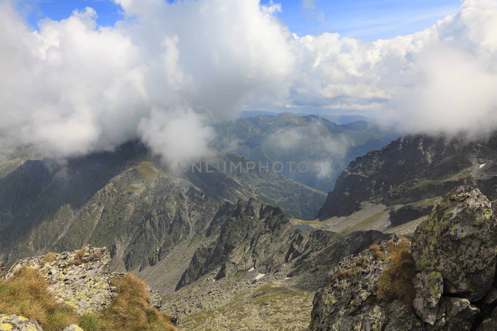 Clouds,rocks and beauty in Fagaras mountains,Romania.In the distance you can se Caltun Lake.The point of view is near the Negoiu summit,which is the second highest mountain top (2635 m) in this mountain range.