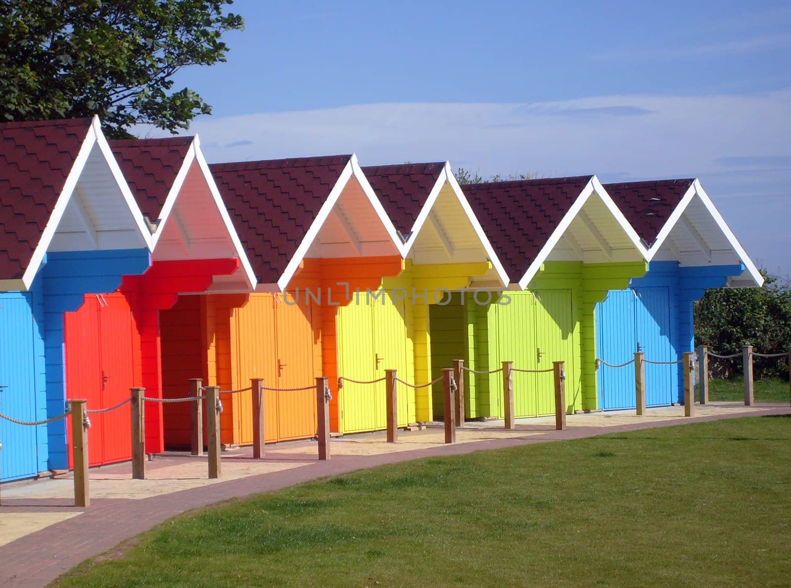 Exteriors of beautiful bright seaside beach chalets, Scarborough, England.