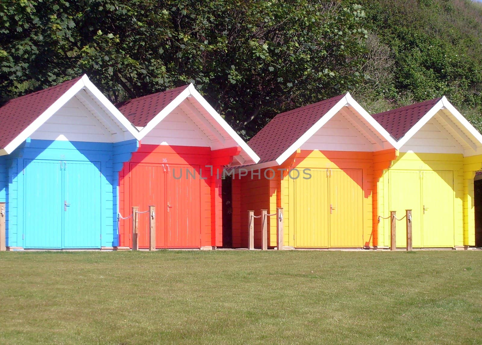 Exteriors of beautiful bright seaside beach chalets, Scarborough, England.