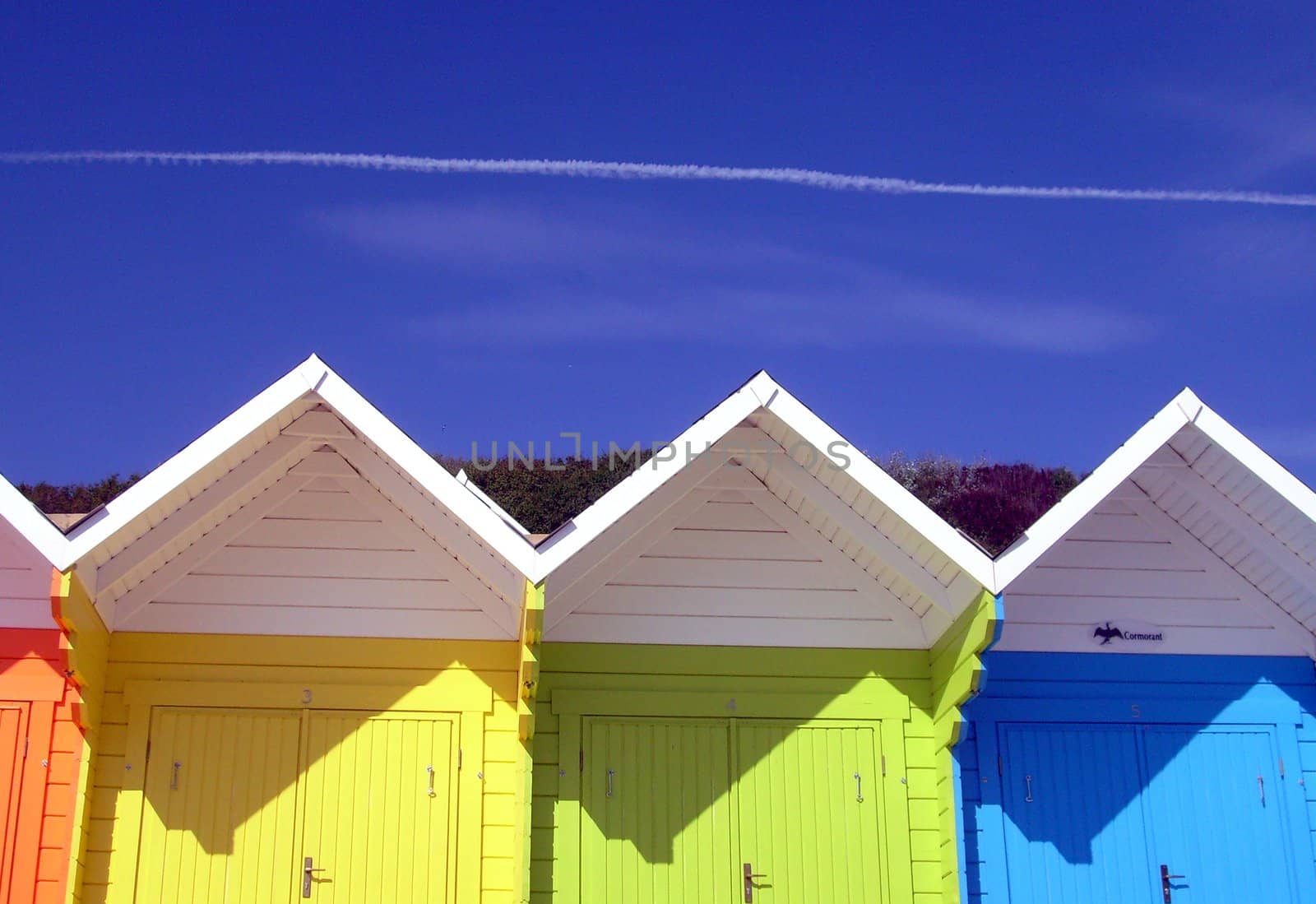 Exteriors of beautiful bright seaside beach chalets, Scarborough, England.