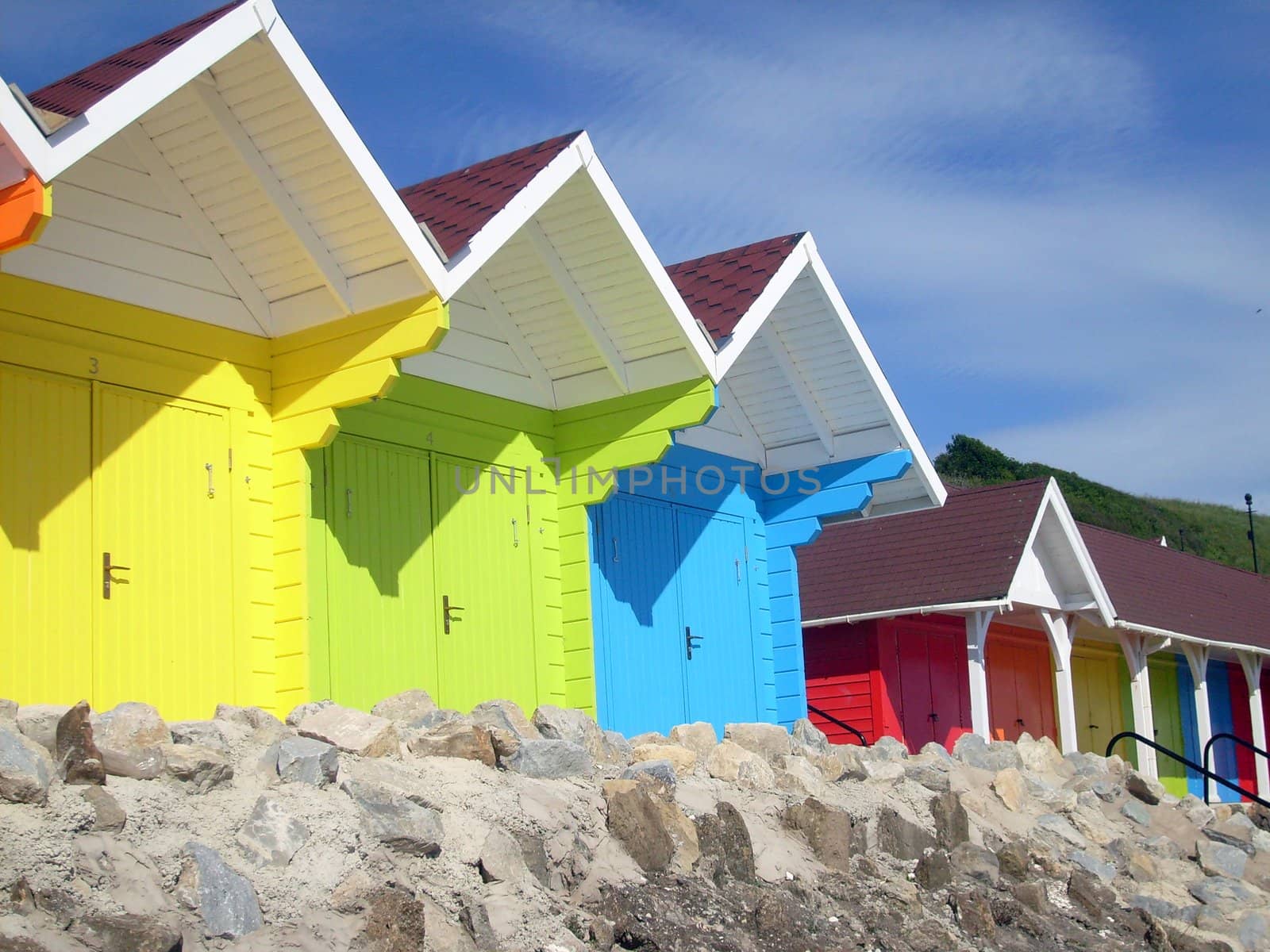 Exteriors of beautiful bright seaside beach chalets, Scarborough, England.