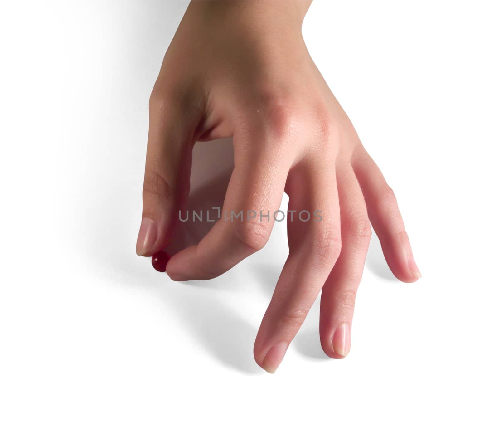 red capsule in woman hand. Isolated on white