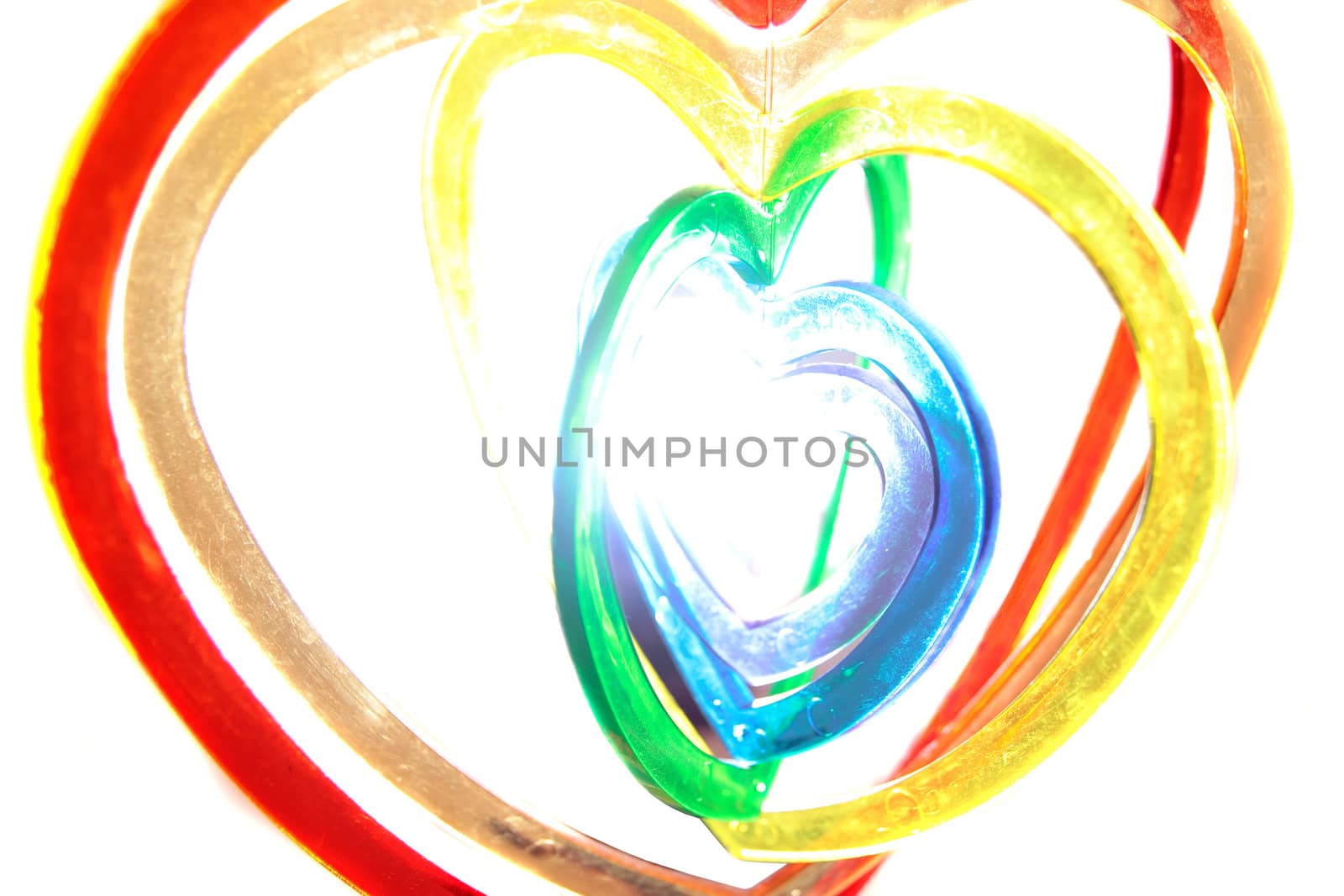 six heart shaped plastic pieces one inside the other on a white background