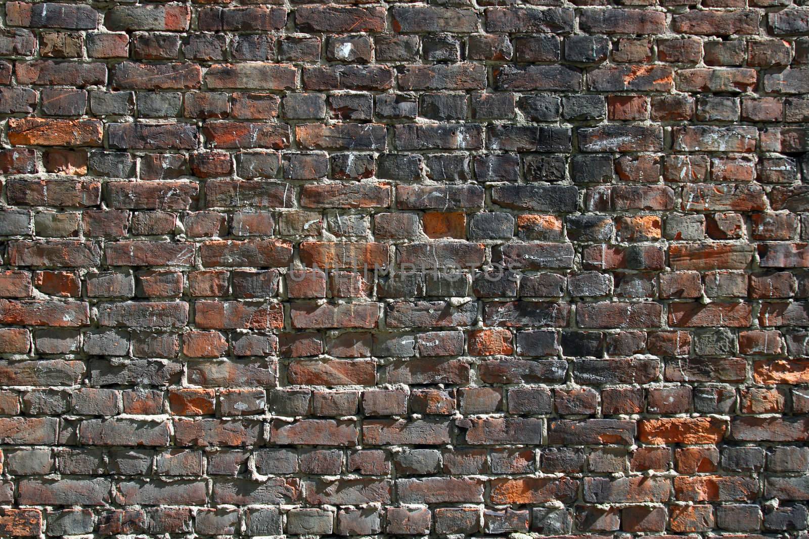 old stained dark brick wall