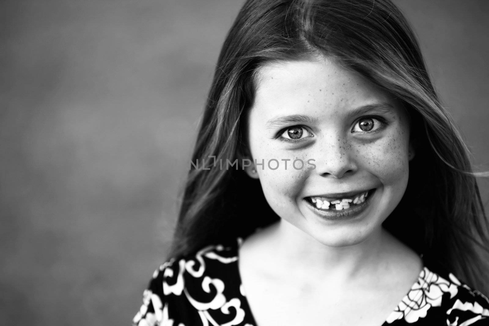 Pretty Young Girl with Freckles and a Big Smile and Crooked Teeth