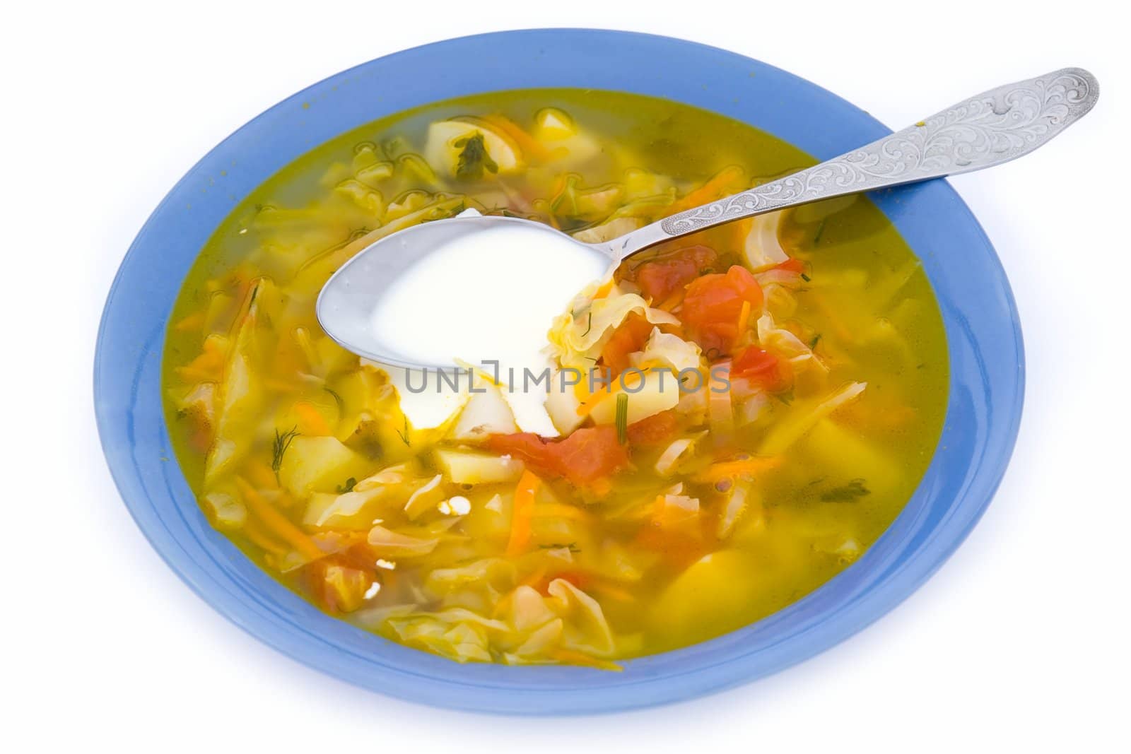 Plate with soup on a white background