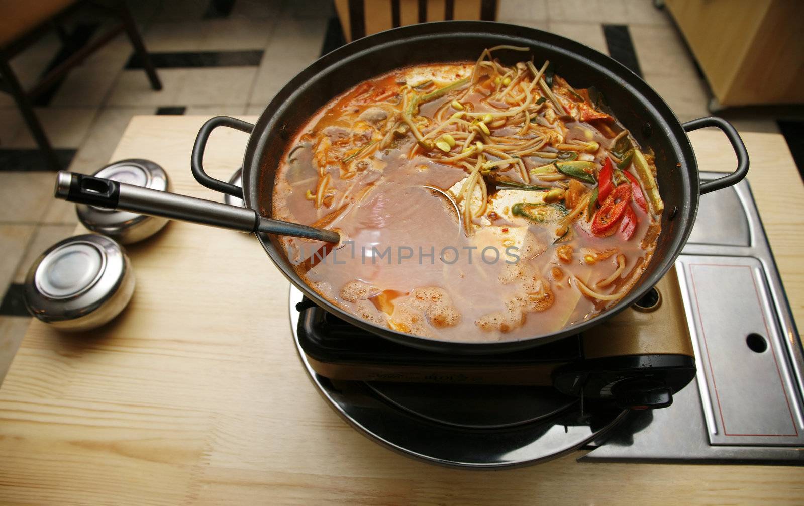 Delightful healthy Asian kitchen - magnificent and nutritious Korean soup with noodles and seafoods