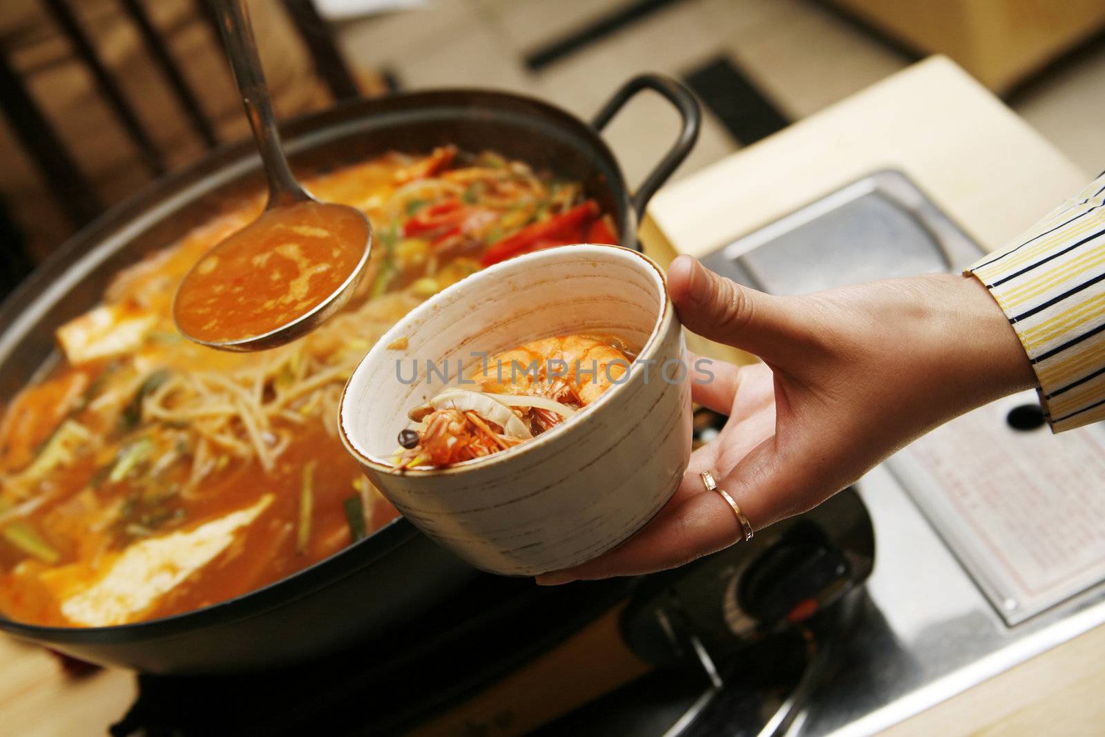 Delightful healthy Asian kitchen - magnificent and nutritious Korean soup with noodles and seafoods